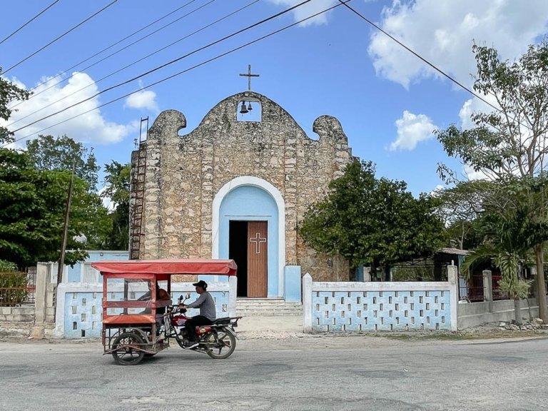 small cart in front of an old church