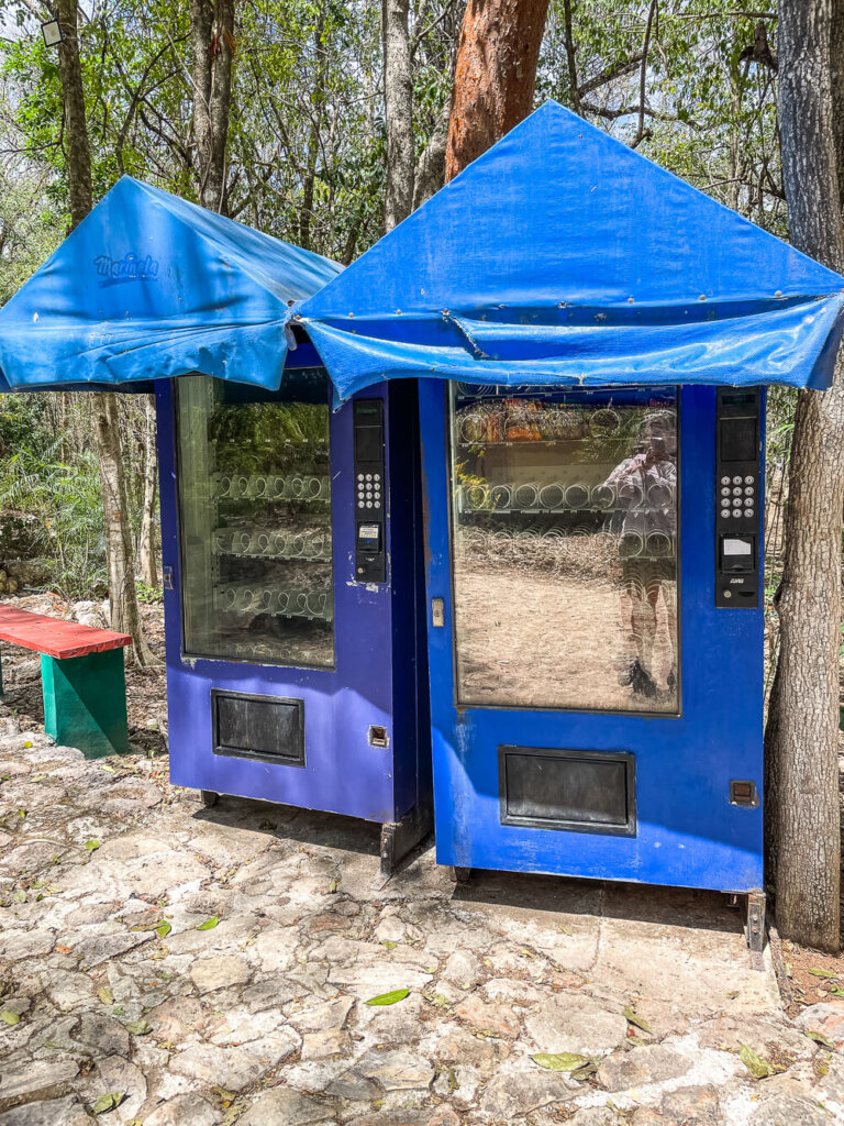 Two blue vending machines with blue awnings