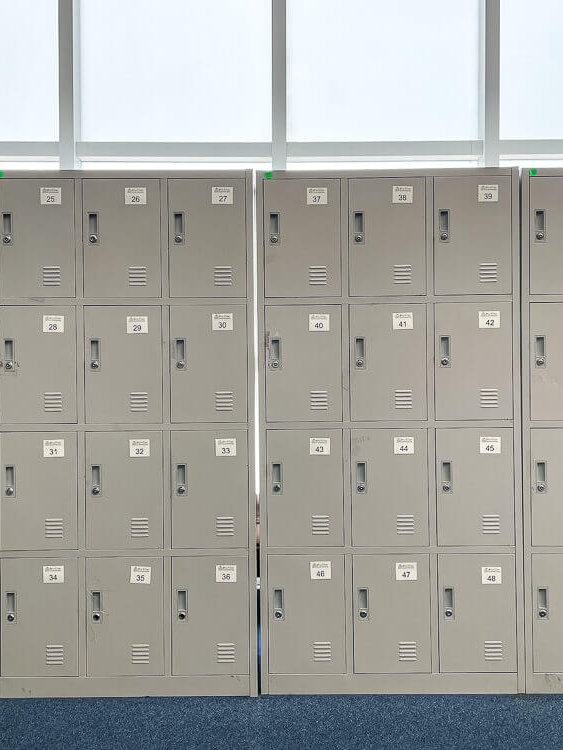 A wall of grey lockers, with small windows above