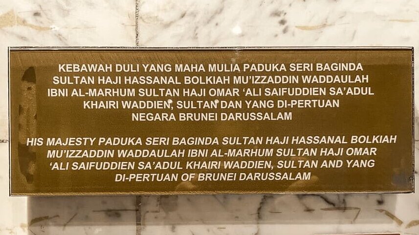 A gold plaque on a marble background with words in white