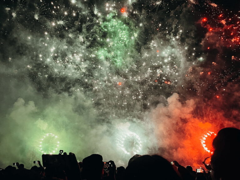 Green, white and red fireworks in the night sky