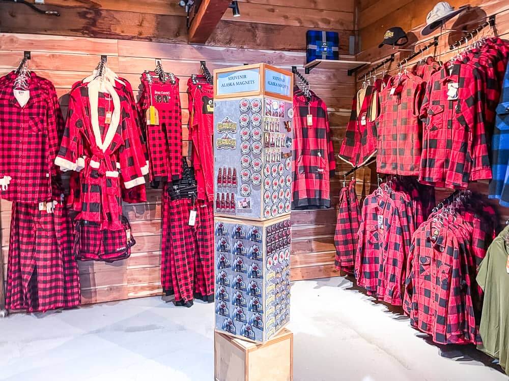 A wall full of black and red plaid shirts and pyjamas for sale.