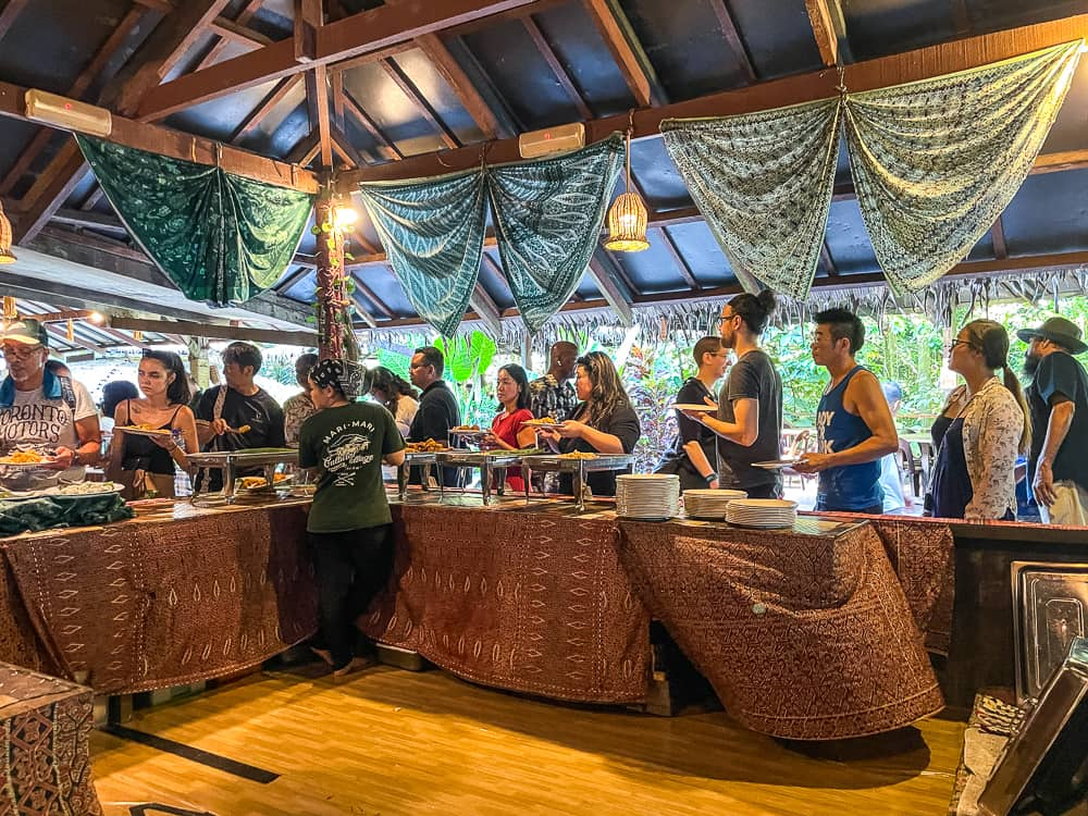 People stand behind tables.